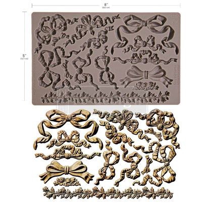 Decorative silicone mold with floral and bow designs on a white background