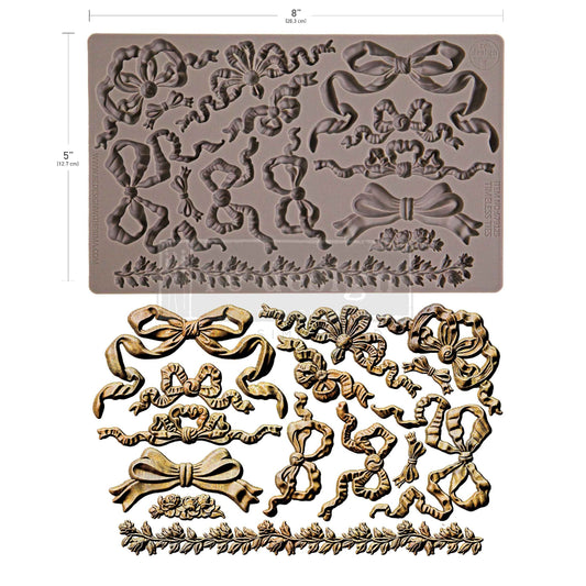 Decorative silicone mold with floral and bow designs on a white background