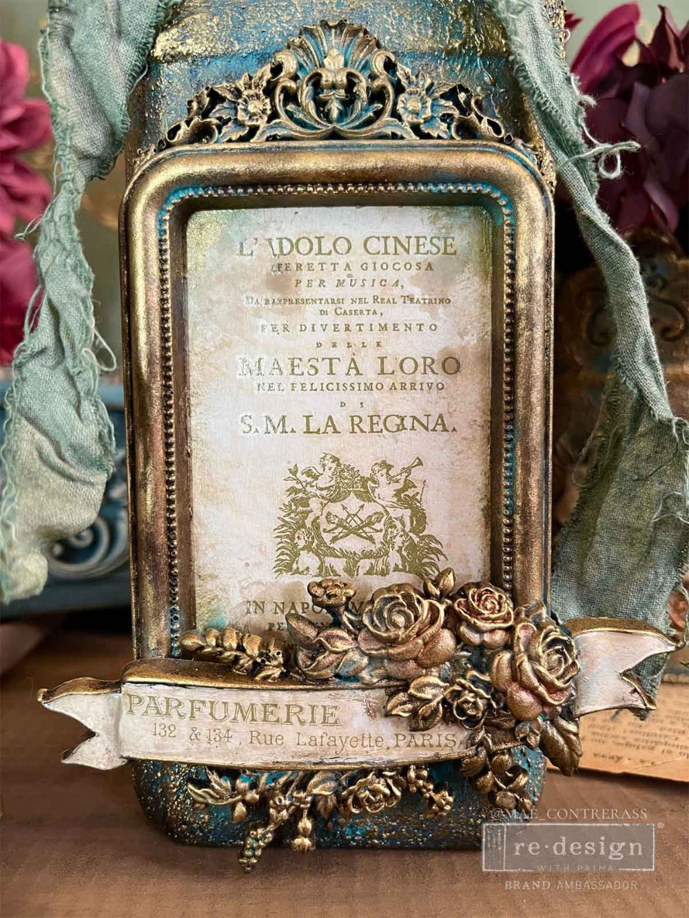 Decorative vintage-style frame with intricate details and text, featuring a floral design.